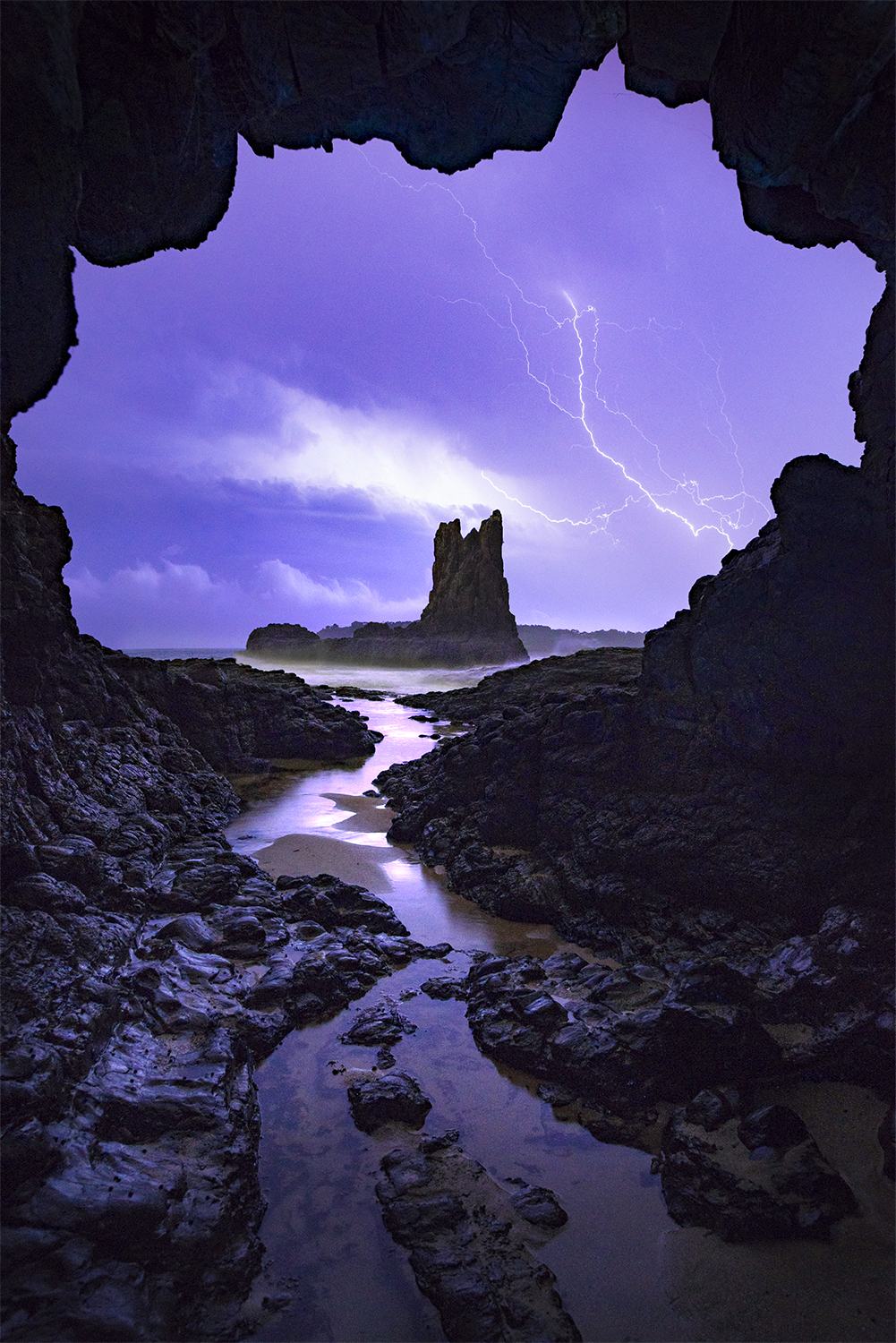 Lightning storm outside a sea cave 