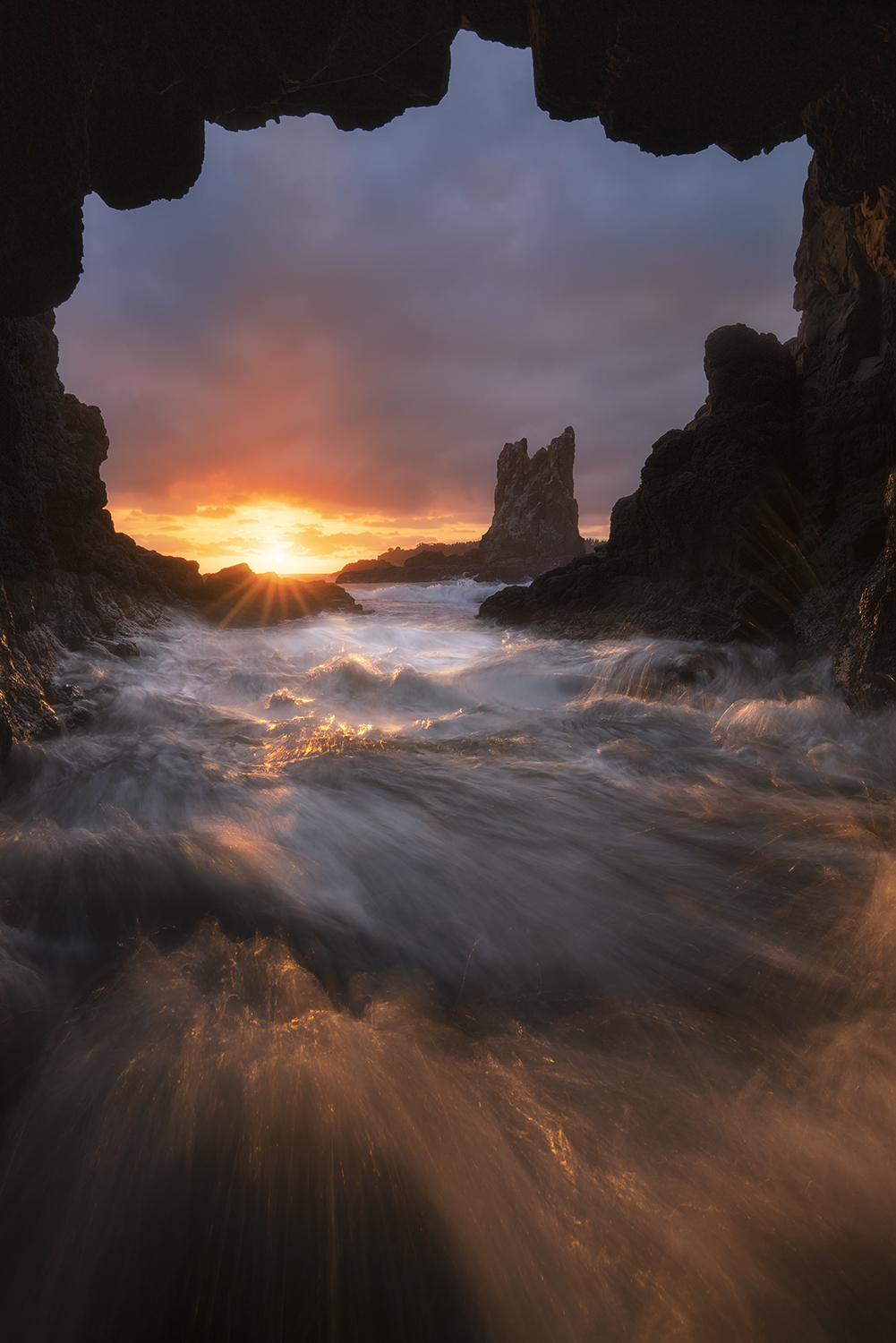 Water rushing inside a sea cave at sunrise