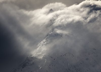 Mountain breaking through cloud
