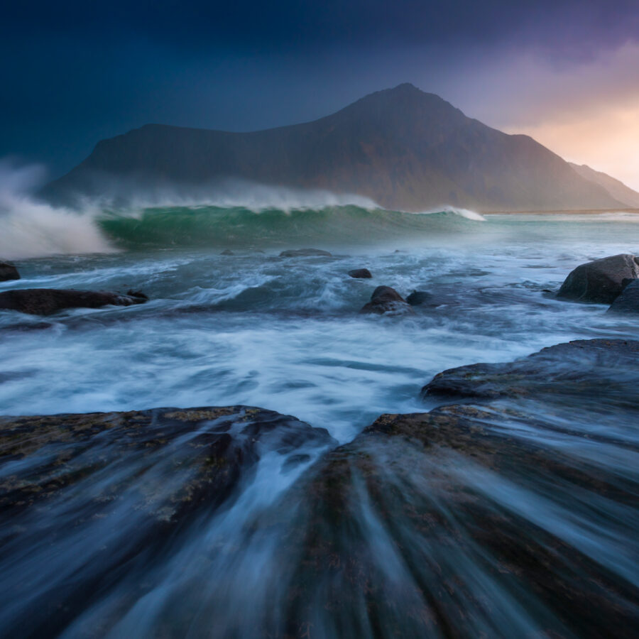 Large swell and mountains by the sea. Lofoten Islands, Norway.
