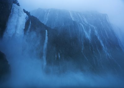 Towering waterfalls and heavy rain in Fiordland, New Zealand