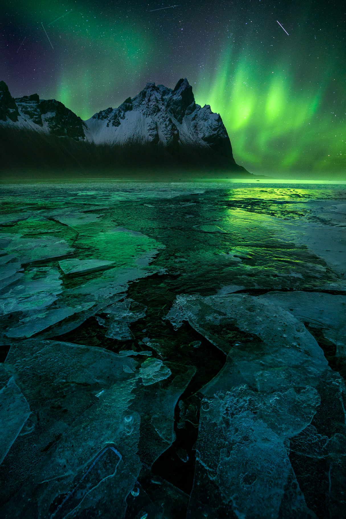Frozen ice and the aurora over Vesturhorn in Iceland