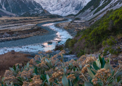 Glacial river leading to a snow capped mountain i nNew Zealand.