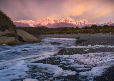 Beach and Southern Alps sunset, New Zealand. Photography by William Patino.